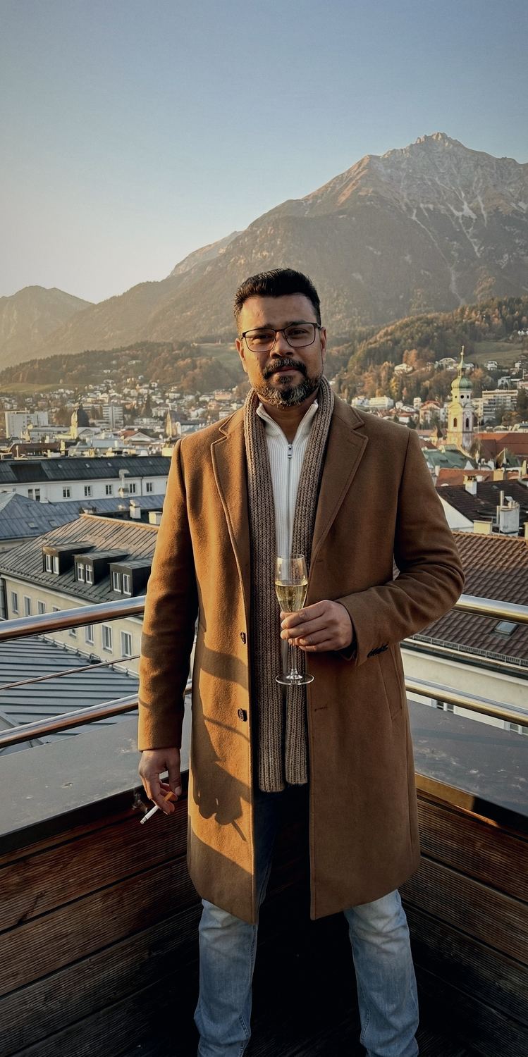 Avishek Biswas on a rooftop terrace above Innsbruck, the Nordkette behind him.